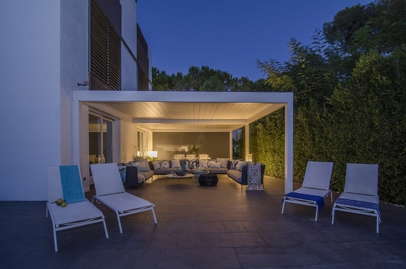 A pergola privacy wall idea with plants.