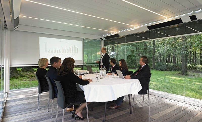 Pergola with glass walls, louvered roof, lighting and heating.
